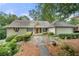 Charming single-Gathering home with stone walkway and well-manicured landscaping for great curb appeal at 5065 Nesbit Ferry Ln, Atlanta, GA 30350