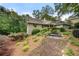View of home's exterior elevation showcasing front of house and beautiful yard with mature trees and flowers at 5065 Nesbit Ferry Ln, Atlanta, GA 30350