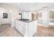 Bright kitchen features a center island with granite countertop and white cabinetry at 5065 Nesbit Ferry Ln, Atlanta, GA 30350