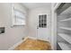 Laundry room features tile flooring, a utility sink connection, and open shelving at 5065 Nesbit Ferry Ln, Atlanta, GA 30350