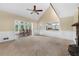 Bright and airy living room featuring vaulted ceiling, fireplace, and view into the dining room and kitchen at 5065 Nesbit Ferry Ln, Atlanta, GA 30350