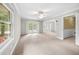 Expansive living room with large windows and carpeted floors at 5065 Nesbit Ferry Ln, Atlanta, GA 30350
