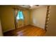 Bedroom featuring hardwood floors, a window, and a built-in shelf at 5508 Zanola Sw Dr, Mableton, GA 30126