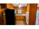 Wood paneled kitchen with stainless sink, white oven and black refrigerator at 5508 Zanola Sw Dr, Mableton, GA 30126