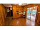 Wood-paneled kitchen and dining area with sliding door access to screened deck at 5508 Zanola Sw Dr, Mableton, GA 30126