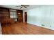 Spacious living room featuring hardwood floors, built-in shelving and a ceiling fan at 5508 Zanola Sw Dr, Mableton, GA 30126
