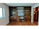 Living room featuring hardwood floors and built-in shelving and cabinets at 5508 Zanola Sw Dr, Mableton, GA 30126