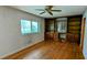 Sunlit living room featuring hardwood floors, built-in shelving, and a ceiling fan at 5508 Zanola Sw Dr, Mableton, GA 30126