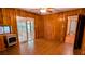 Spacious living room with wood paneled walls, ceiling fan and slider to the screened deck at 5508 Zanola Sw Dr, Mableton, GA 30126