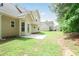 The backyard features a patio, lawn, and the back of the home with neutral siding and black trim windows at 5380 Bridle Point Pkwy, Snellville, GA 30039