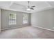 Spacious bedroom featuring neutral walls, a ceiling fan, and large windows for ample natural light at 5380 Bridle Point Pkwy, Snellville, GA 30039