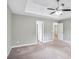 A bright bedroom featuring neutral walls, carpet, and a ceiling fan, with doorways leading to other rooms at 5380 Bridle Point Pkwy, Snellville, GA 30039