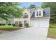 Charming two-story home featuring a two-car garage, manicured lawn, and inviting curb appeal at 5380 Bridle Point Pkwy, Snellville, GA 30039