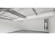 Spacious garage with epoxy floor, white walls, garage door mechanism, and a water heater at 5380 Bridle Point Pkwy, Snellville, GA 30039