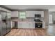 Modern kitchen equipped with stainless steel appliances, granite countertops, and white cabinetry at 5380 Bridle Point Pkwy, Snellville, GA 30039