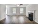Living room featuring a fireplace, hardwood flooring, and ample natural light at 5380 Bridle Point Pkwy, Snellville, GA 30039