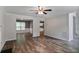 Open-concept layout featuring hardwood flooring and neutral walls connecting the living room and dining area at 5380 Bridle Point Pkwy, Snellville, GA 30039