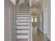 Welcoming entryway featuring a staircase, light gray door, and hardwood floors at 615 Leafy Branch Way, Mcdonough, GA 30253