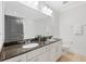 Bathroom features a double sink vanity with granite countertop and framed mirror at 625 Piedmont Ne Ave # 105, Atlanta, GA 30308