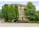 Brick apartment building featuring lush landscaping and mature trees at 625 Piedmont Ne Ave # 105, Atlanta, GA 30308