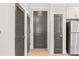 Hallway view with hardwood floors and access to a modern stainless steel refrigerator at 625 Piedmont Ne Ave # 105, Atlanta, GA 30308