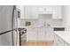 Well-lit kitchen featuring stainless steel appliances, white cabinets, and a center island at 625 Piedmont Ne Ave # 105, Atlanta, GA 30308