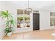 Bright living room with hardwood floors, large windows, and modern lighting fixture at 625 Piedmont Ne Ave # 105, Atlanta, GA 30308