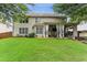 Spacious backyard with covered patio, lush lawn, and charming exterior at , Atlanta, GA 30360