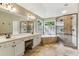 Bright bathroom featuring double vanity, soaking tub, walk-in shower, and neutral-toned tile throughout at , Atlanta, GA 30360