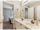 Bright bathroom featuring double vanity, neutral-toned paint, and doorway access to bedroom at , Atlanta, GA 30360