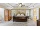 Spacious primary bedroom with tray ceiling, neutral colors, and plantation shutters on the windows at , Atlanta, GA 30360
