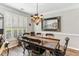 Elegant dining room featuring a rustic table, chandelier, and neutral wall color at , Atlanta, GA 30360