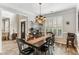 Dining room with dark wood table and floors, chandelier, and large windows at , Atlanta, GA 30360