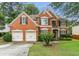 Charming two-story brick home with a well-manicured lawn and a two-car garage at , Atlanta, GA 30360