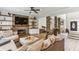 Comfortable living room with a stone fireplace, built-in shelves and modern ceiling fan at , Atlanta, GA 30360