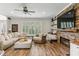 Cozy living room with a stone fireplace, wooden floors and a large window for natural light at , Atlanta, GA 30360