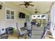 Outdoor patio seating area with a ceiling fan, TV, and views of the backyard at , Atlanta, GA 30360