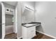 Bathroom with wood-look flooring, vanity, and a large mirror with a light fixture at 1086 Erie Cir, Stone Mountain, GA 30087