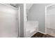 Bright bathroom featuring a soaking tub, glass enclosed shower, and a door to the closet at 1086 Erie Cir, Stone Mountain, GA 30087