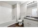 Modern bathroom features a tub, shower, vanity, and wood-look flooring at 1086 Erie Cir, Stone Mountain, GA 30087