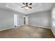 Spacious bedroom features neutral paint, a fan, trey ceilings and carpeted floors at 1086 Erie Cir, Stone Mountain, GA 30087