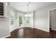 Bright breakfast nook featuring dark wood floors, a chandelier, and a door leading to the backyard at 1086 Erie Cir, Stone Mountain, GA 30087