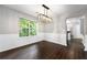Bright dining room with large window, wainscoting, and modern chandelier at 1086 Erie Cir, Stone Mountain, GA 30087