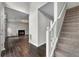 Inviting entryway featuring wood-look tile floors, staircase, and an open view into the living room at 1086 Erie Cir, Stone Mountain, GA 30087