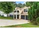 Two-story home with a balcony, attached two-car garage, and a well-manicured front yard at 1086 Erie Cir, Stone Mountain, GA 30087