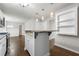 Stylish kitchen island with bar seating, elegant pendant lighting, and modern cabinetry at 1086 Erie Cir, Stone Mountain, GA 30087
