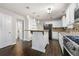 Well-appointed kitchen featuring white cabinetry, stainless steel appliances and wood-look tile flooring at 1086 Erie Cir, Stone Mountain, GA 30087