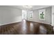 Bright living room featuring wood-look tile floors, a fireplace, and large windows at 1086 Erie Cir, Stone Mountain, GA 30087