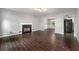 Spacious living room with a cozy fireplace, wood-look tile floors and ample natural light at 1086 Erie Cir, Stone Mountain, GA 30087