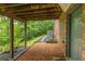 A cozy backyard patio featuring a brick exterior, a door, and a view of the lush green surroundings at 2892 Guinevere Ne Dr, Atlanta, GA 30345